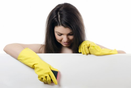 Trained carpet cleaner using protective gloves and mask during cleaning